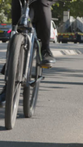 Vertical-Video-Of-Cyclists-Cycle-Lane-Commuting-To-Work-In-Busy-London-Street